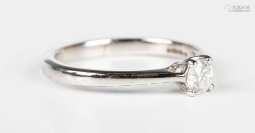 A white gold and diamond single stone ring, claw set with a ...