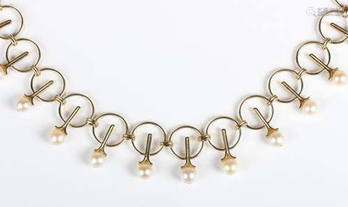A gold and cultured pearl necklace in a circular link design...