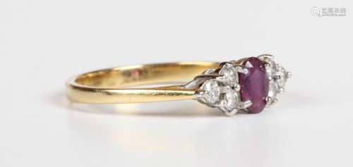 An 18ct gold, ruby and diamond ring, claw set with the oval ...