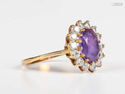 A gold, amethyst and colourless gem set oval cluster ring, c...