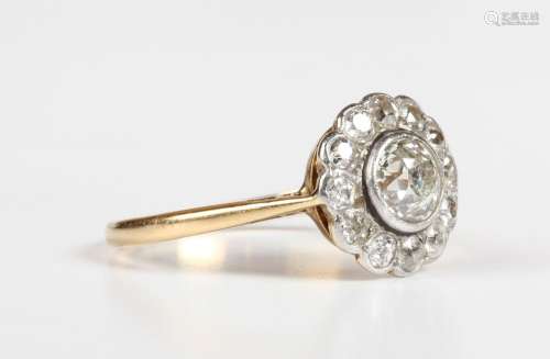 A gold and diamond cluster ring, collet set with the princip...