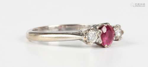 An 18ct white gold, ruby and diamond three stone ring, claw ...