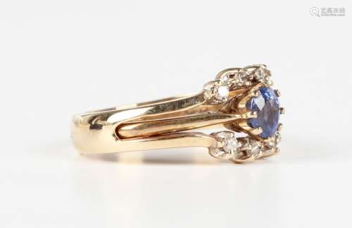A 9ct gold ring, claw set with an oval cut sapphire, London ...