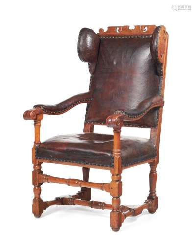 A NORTH EUROPEAN OAK, FRUITWOOD AND LEATHER UPHOLSTERED WING...