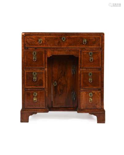 A GEORGE II WALNUT AND FEATHER BANDED KNEEHOLE DESK, CIRCA 1...