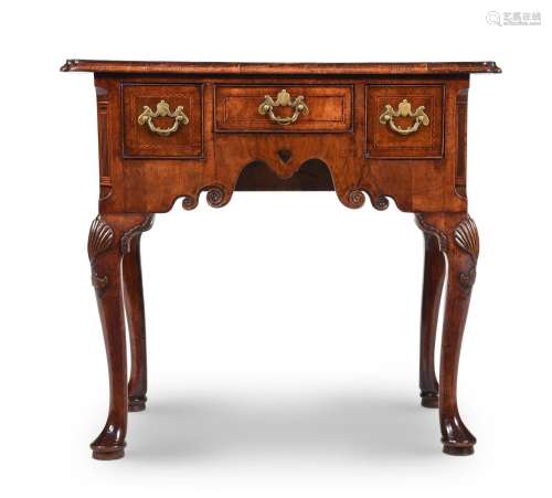 A GEORGE II WALNUT LOWBOY, IN THE MANNER OF GILES GRENDEY, C...