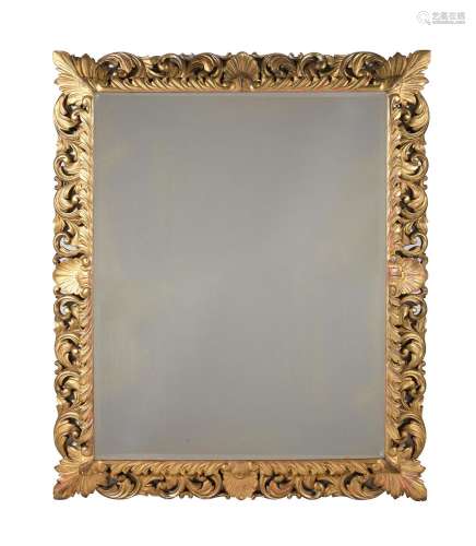 A LARGE FLORENTINE FOLIATE CARVED GILTWOOD MIRROR, SECOND HA...
