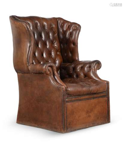 A BUTTONED LEATHER UPHOLSTERED WING ARMCHAIR, IN GEORGE III ...