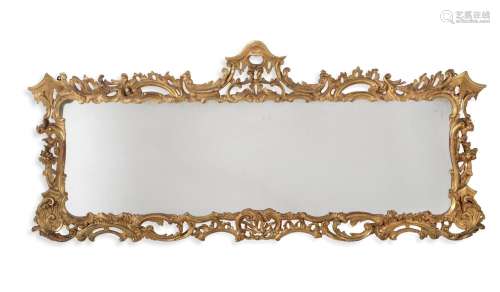 A GEORGE III CARVED GILTWOOD WALL MIRROR, IN THE ROCOCO TAST...