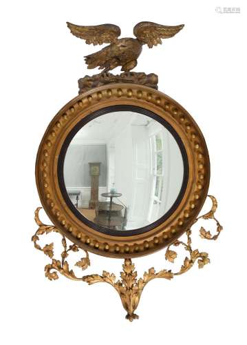 A REGENCY GILTWOOD AND GESSO CONVEX WALL MIRROR OF LARGE PRO...