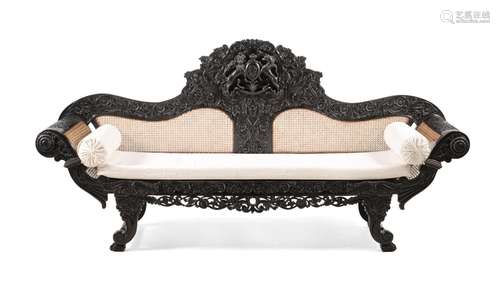 Y A CEYLONESE CARVED EBONY SETTEE, PROBABLY GALLE DISTRICT, ...