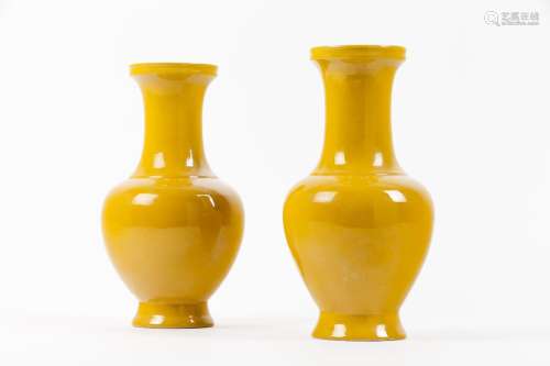 A pair of monochrome yellow baluster vases