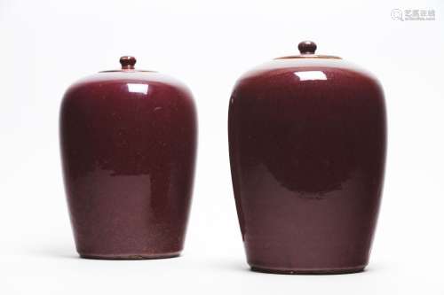 A pair of Chinese flambe-glazed ovoid jars and covers