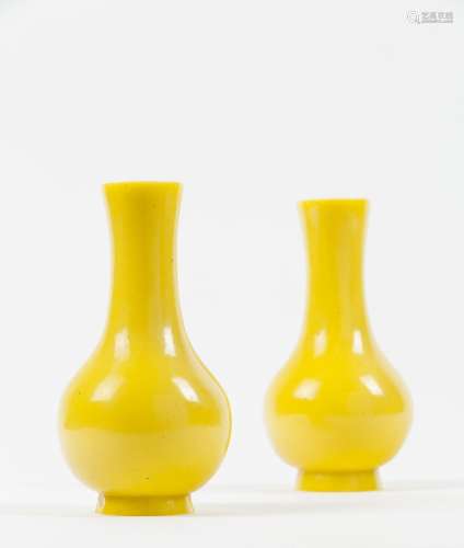 A pair of opaque yellow vases