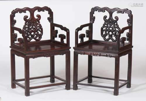 A pair of carved hardwood armchairs