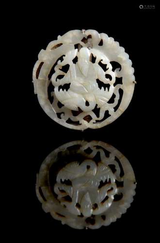 A white jade circular reticulated plaque set in a brooch