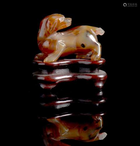A carved jade figure of a recumbent dog