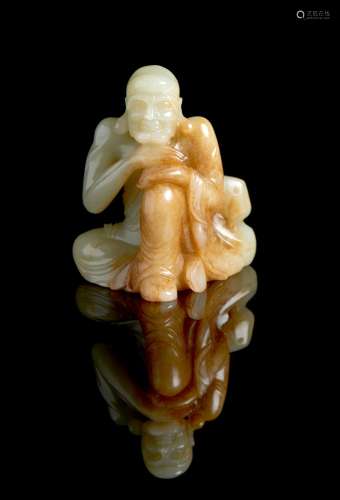 A Chinese celadon and russet jade carving of an ascetic