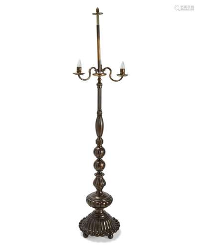 A tall patinated brass floor lamp