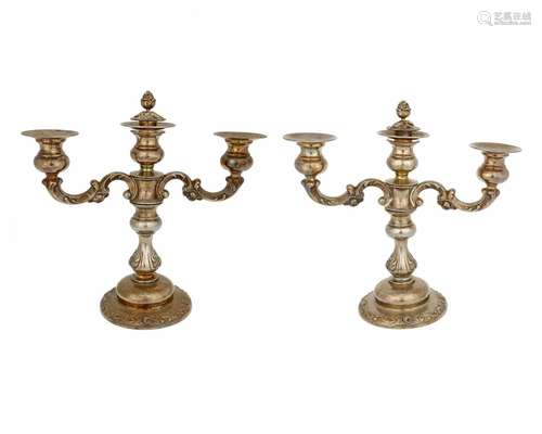 A pair of sterling silver weighted candelabra