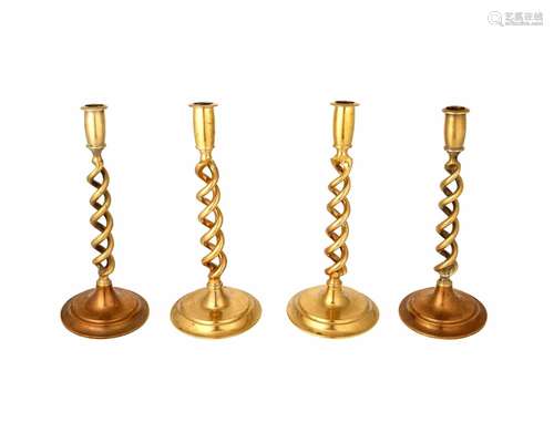 A group of English spiral brass candlesticks