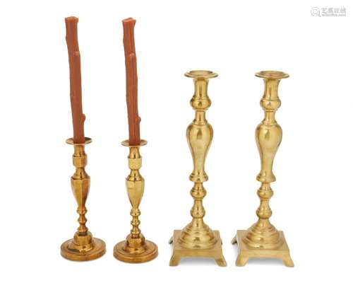 A group of brass candlesticks