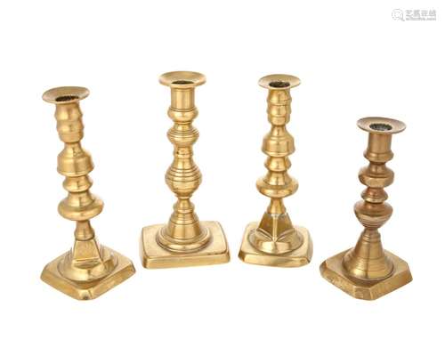 A group of brass candlesticks