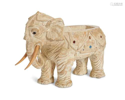A carved wooden elephant planter
