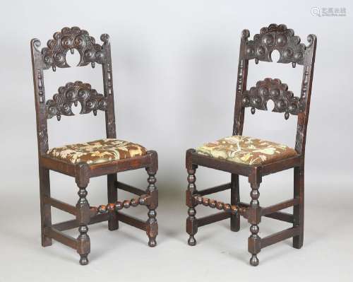 A near pair of 17th century oak Derbyshire chairs with carve...