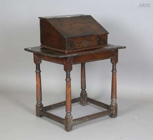 A 17th century oak bible box, the hinged sloping lid enclosi...