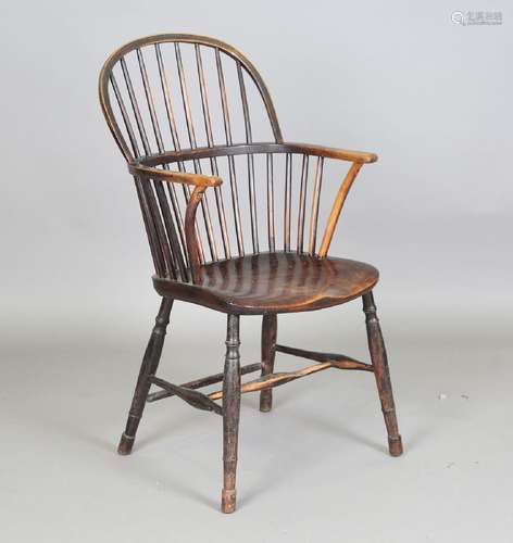 A 19th century fruitwood and elm stick back Windsor armchair...