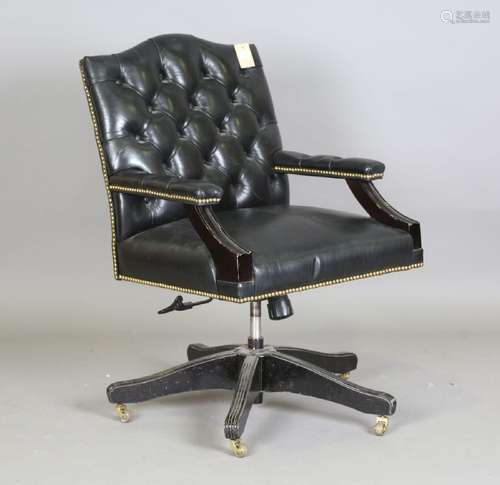 A late 20th century revolving desk chair, upholstered in but...