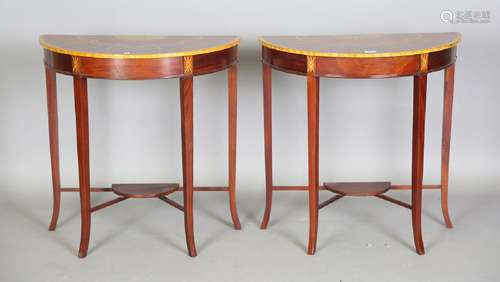 A pair of modern reproduction mahogany demi-lune side tables...