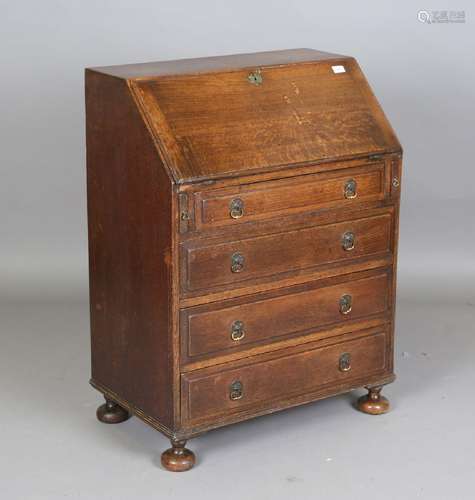 A 20th century Queen Anne style oak bureau of small proporti...