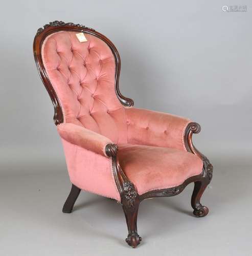 A late Victorian mahogany showframe armchair, upholstered in...