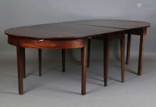 A George III mahogany dining table, formed from a pair of de...