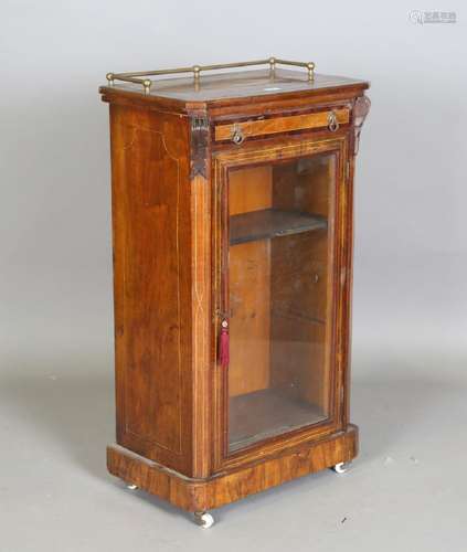 A late Victorian walnut and amboyna crossbanded music cabine...