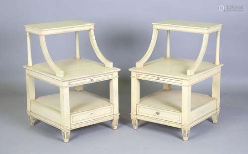 A pair of late 20th century cream painted three-tier bedside...