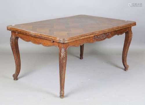 A 20th century French oak parquetry draw-leaf dining table, ...