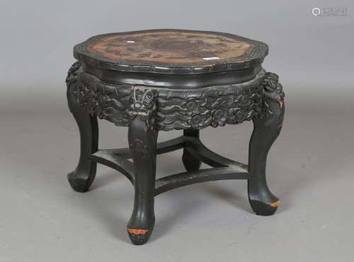 A Chinese ebonized softwood stand, the top incised with figu...