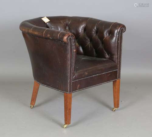 A modern buttoned brown leather tub back armchair, height 77...