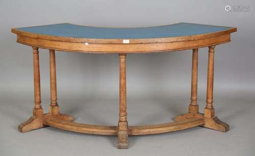 A mid-20th century oak council chambers curved table, the to...