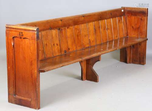 A late 19th century stained pine pew, height 91cm, width 261...