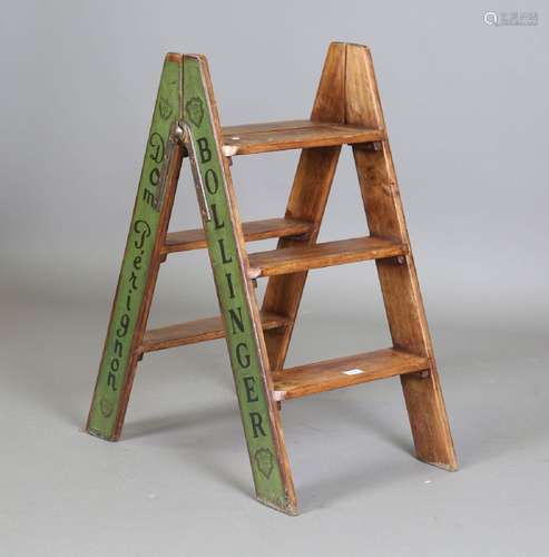 A modern wooden folding stepladder, signwritten to the sides...