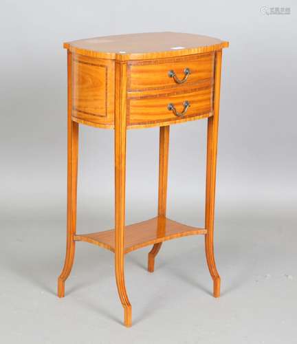 An Edwardian satinwood bedside cabinet with kingwood crossba...