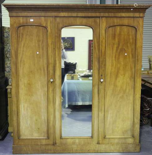 A Victorian mahogany three-door wardrobe, the interior fitte...