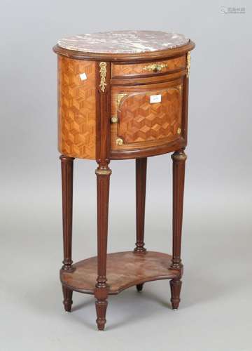 An early 20th century French parquetry kingwood oval bedside...