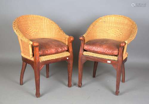 A pair of modern hardwood and rattan armchairs with brown le...