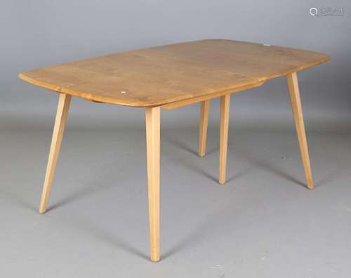 An Ercol pale elm extending dining table, fitted with two ex...