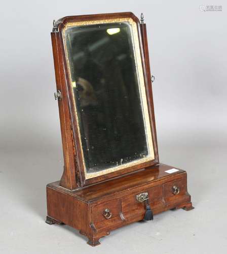 A George II mahogany swing frame mirror, the base fitted wit...